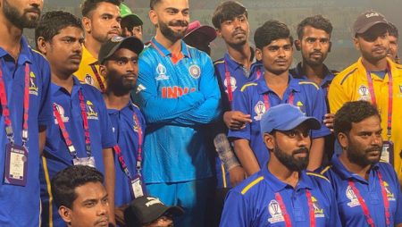 Virat Kohli poses with ground staff at Eden Gardens following India’s victory against South Africa