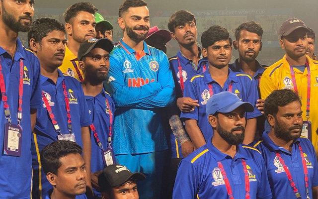 Virat Kohli poses with ground staff at Eden Gardens following India’s victory against South Africa